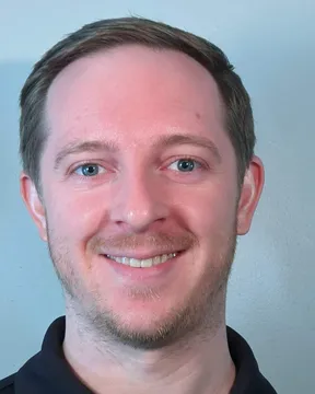 Jason Jamieson, smiling, in a dark polo shirt